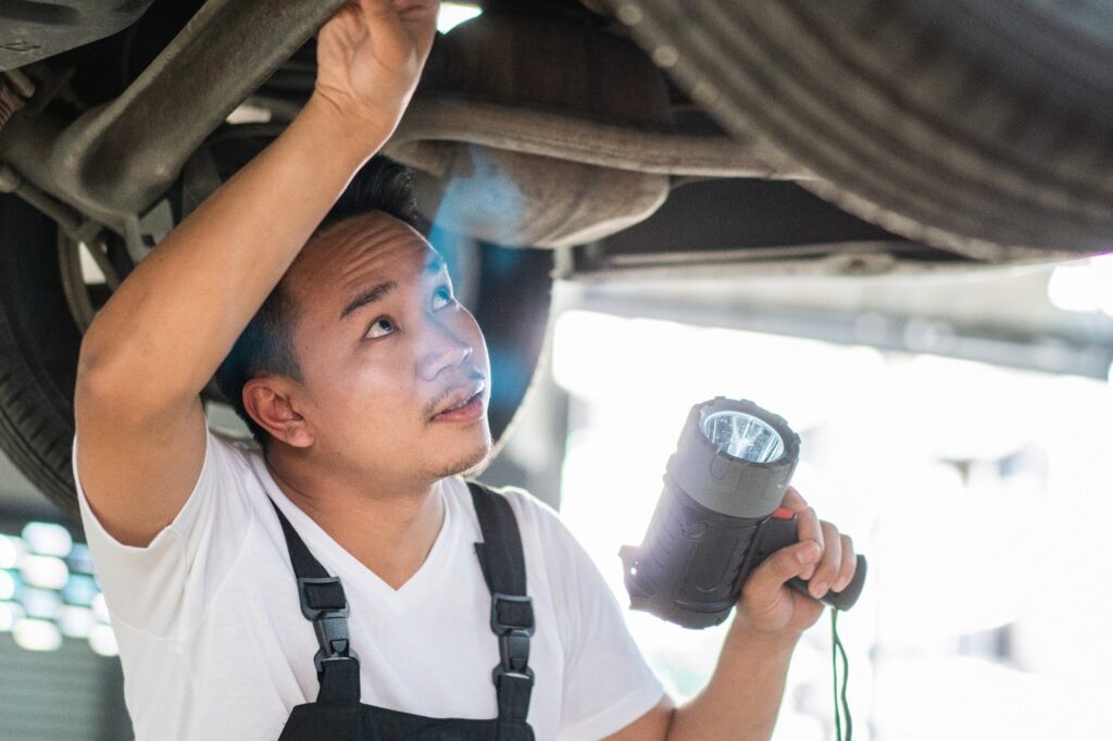 A mechanic checking out a car