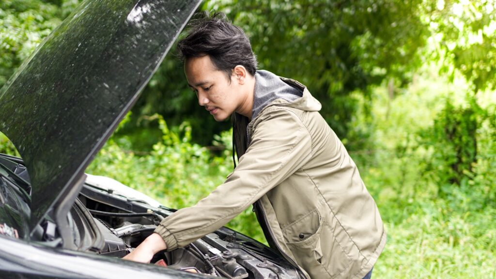 A guy checking his car engine
