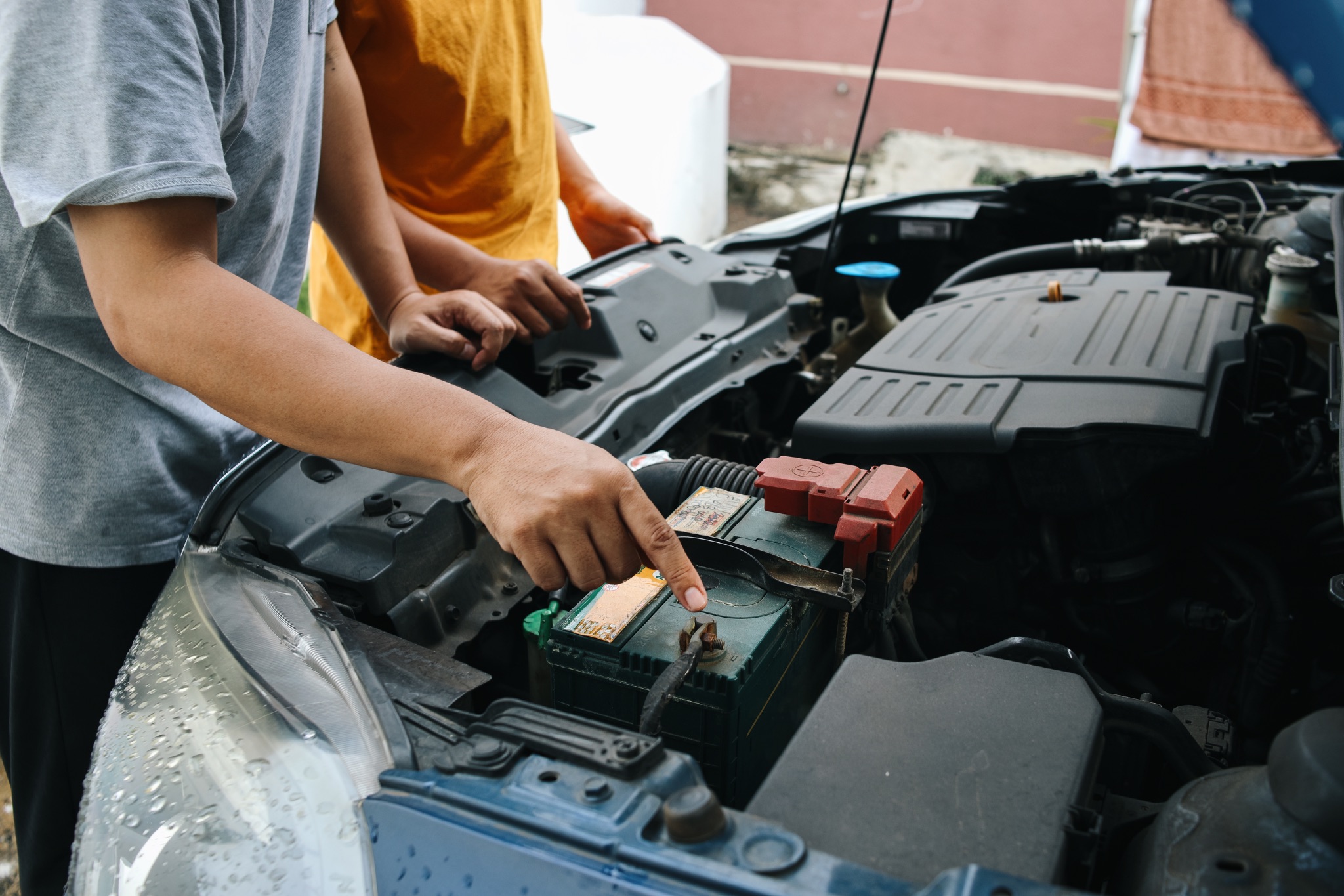 Mechanic inspecting car battery