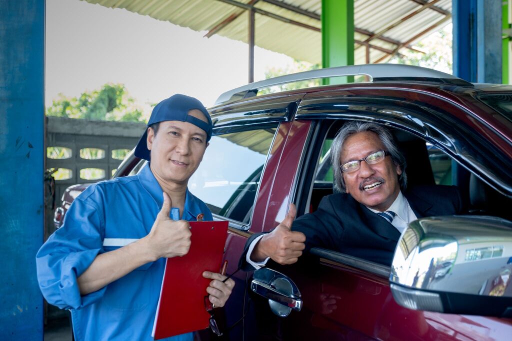 Mechanic and customer giving a thumbs up