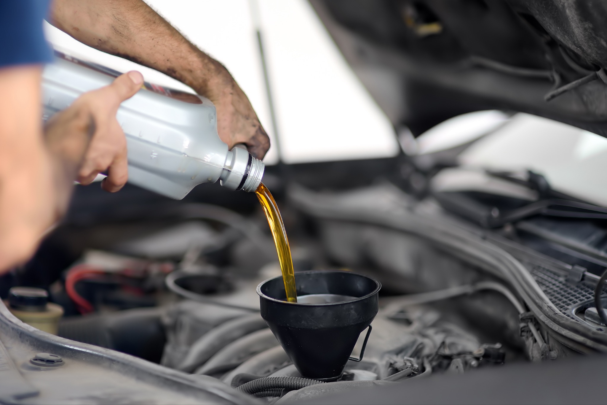 Person adding in engine oil