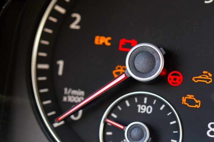 Close up shot of a rev counter with warning lights