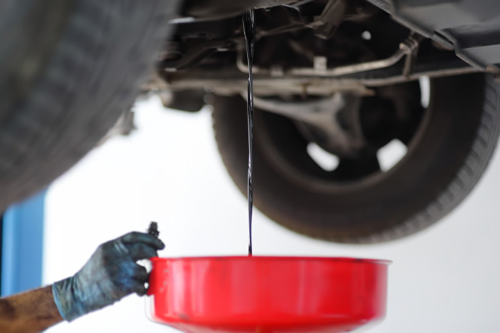 Mechanic Flushing Out Dirty Engine Oil